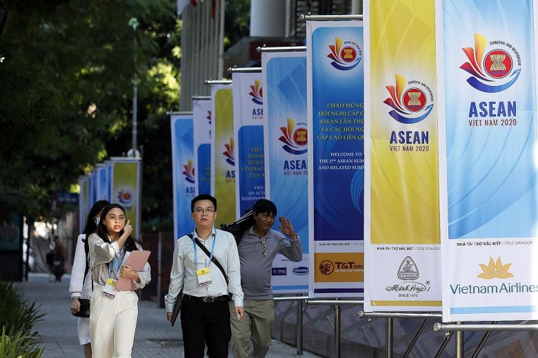 Banners promoting this week's Asean Summit line the street in Hanoi, Vietnam. Regional leaders will meet virtually and focus on an agenda that includes the completion of the Regional Comprehensive Economic Partnership deal and the launch of the region's reserve stockpile of essential medical supplies.PHOTO: EPA-EFE